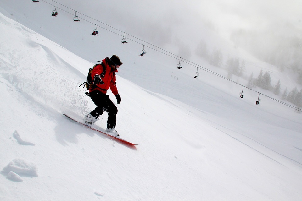 a man snowboarding down the mountain
