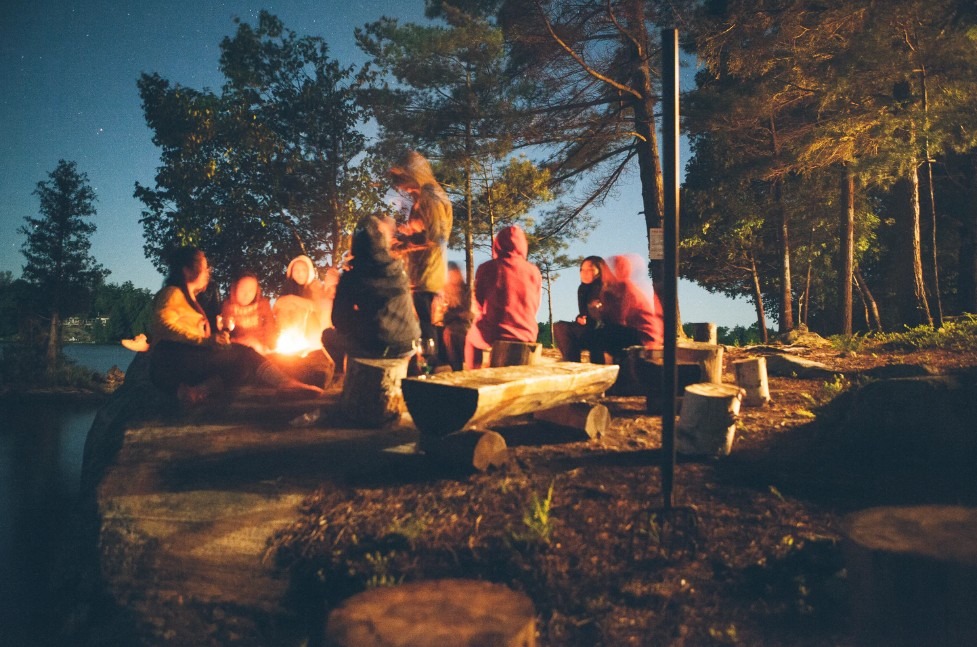 Campers gathered around a campfire