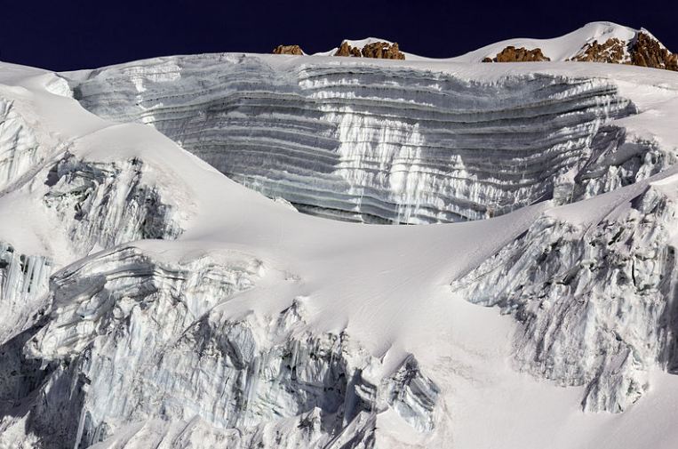 Layers of glaciers covering a portion of the mountain