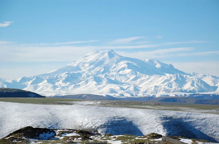 Mount Elbrus appears white covered with thick glaciers and ice