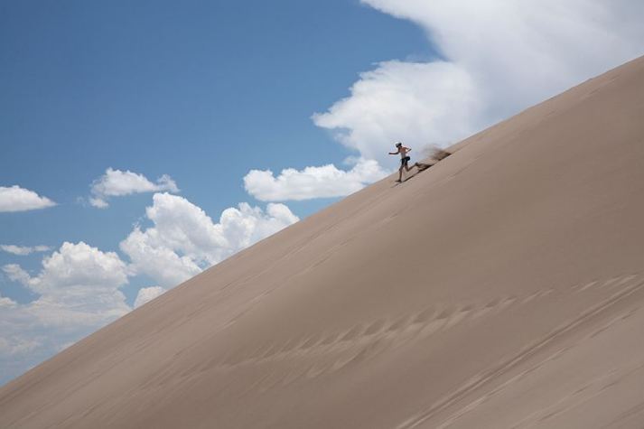 A Visitor Running down the Great Sand Dunes National Park