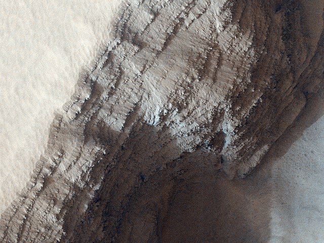 Layers from numerous lava flowson the side of a pit on the lower west flank of Arsia Mons