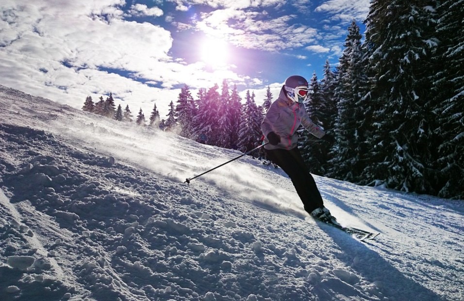 a skier skiing on track in a sunny weather