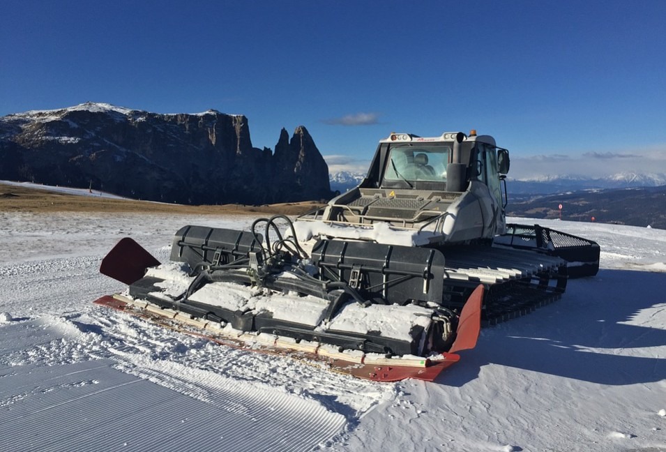 a snow cat creating trails for skiers