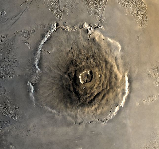 brown wide surface, small crater in the middle