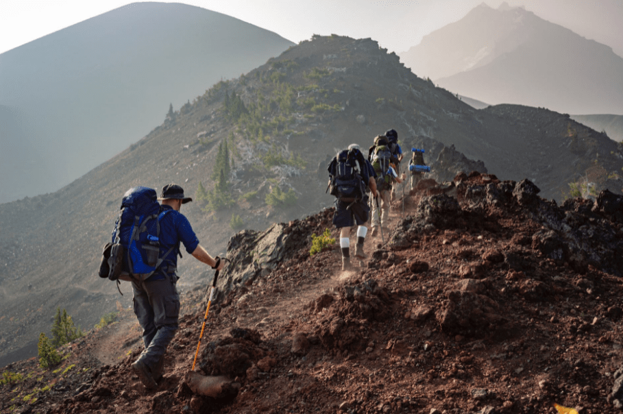 Group of People Walking on Mountain.