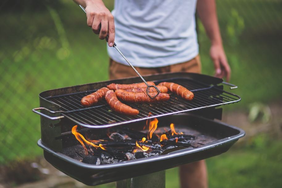 man grilling some sausages