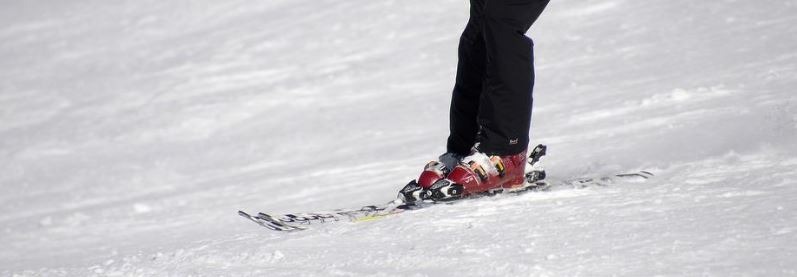 a close up photo of a skier wearing ski boots on skis