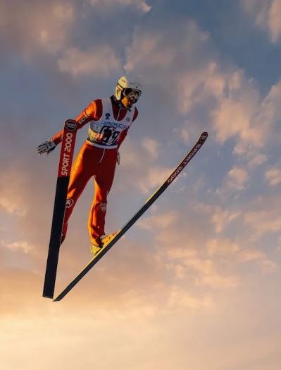 a ski jumper high up the sky